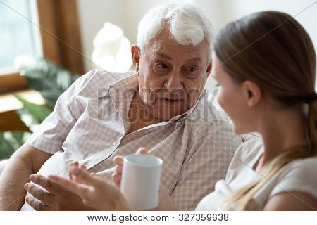 Close Up Focus On Old Man Speaking With Adult Daughter