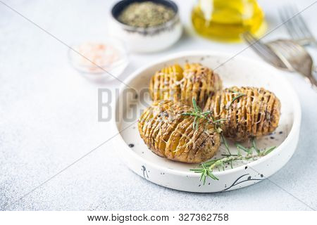 Baked Hasselback Potatoes With Cheese, Garlic And Greens