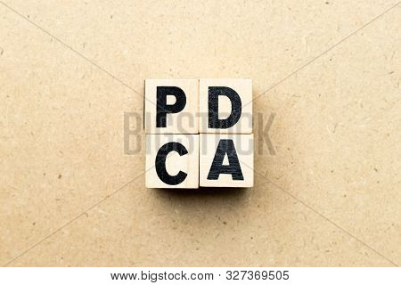 Alphabet Letter Block In Word Pdca (business Abbreviation Of Plan Do Check Act) On Wood Background
