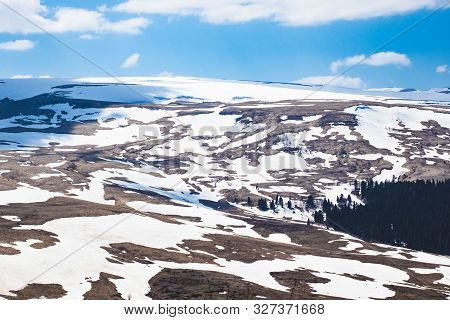 Lago Naki Spring Plateau With Snowy Hills, Blue Sky And Clouds