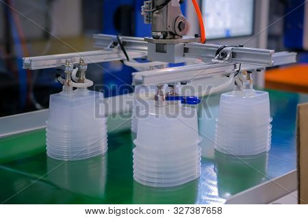 Stack Of Polypropylene Food Containers On Conveyor Belt Of Automatic Plastic Injection Molding Machi
