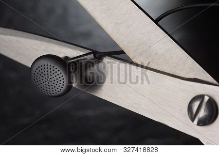 Scissors Cutting Wire On Earbuds. True Wireless Stereo Tws Earphones Concept