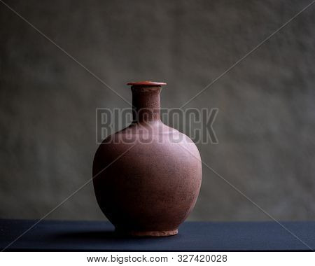 Earthen Pot, The Best Drinking Water You Can Get! In Color On Black Desk And Lots Of Copy Space