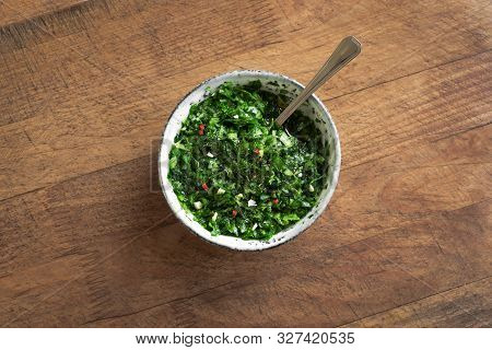 Raw Homemade Chopped Green Chimichurri Or Chimmichurri Sauce Made Of Parsley, Garlic, Oregano, Hot P