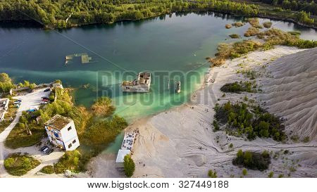 Sand Hills Of Quarry With A Pond And Abandoned Prison In Rummu Estonia Europe. Flooded Houses Of For