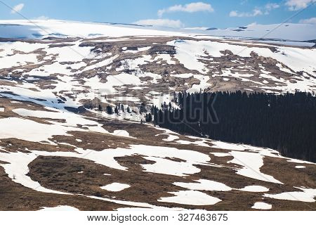Lago Naki Spring Plateau With Snowy Hills, Blue Sky And Clouds