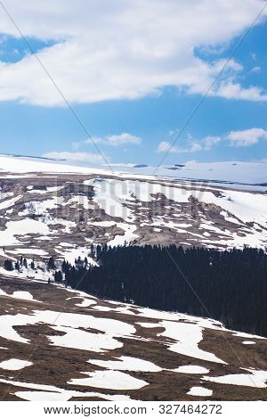 Lago Naki Spring Plateau With Snowy Hills, Blue Sky And Clouds, Adygea, Russia.