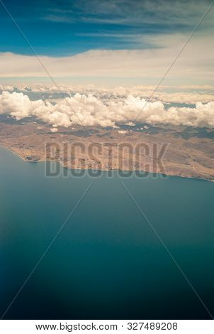 Aerial View Of The Desertic Surroundings Of The Titikaka Lake And The Tiny Houses Around It With Clo