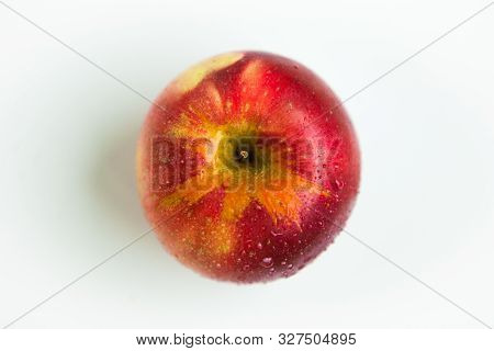 One red apple with the water drops on the white background