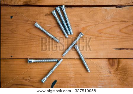 Metalware (bolt, Screw) On The Wooden Background