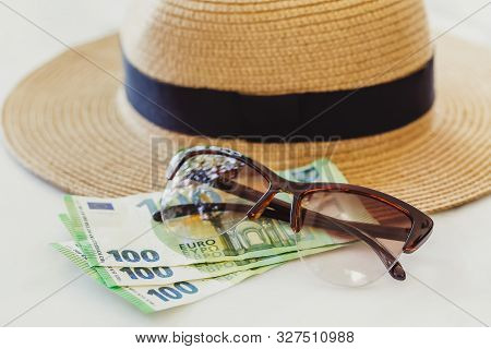 Sun Hat With Sunglasses And 100 Hundredth Euro Banknotes. Money Or Vacation Concept