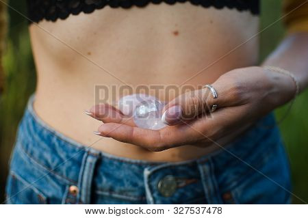 Female Hands Holding Two Yoni Eggs For Vumfit, Imbuilding Or Meditation Are Made From Pink Quartz An