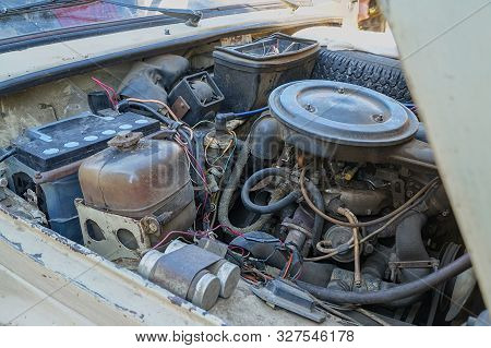 The Engine Compartment Of The Car. Old Dirty Engine
