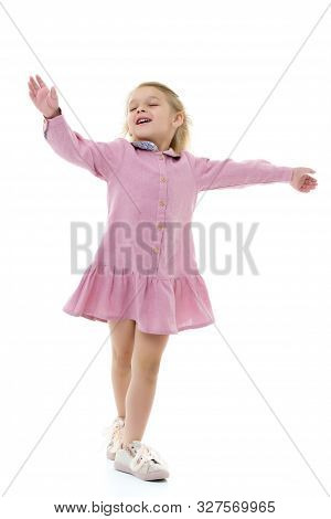 Beautiful Little Girl In A Dress Is Spinning. Concept Of Happy Childhood, Dancing, Holidays. Isolate