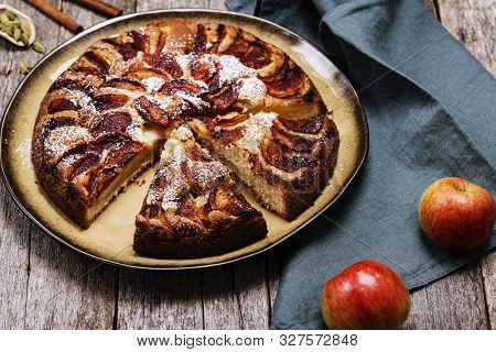 Eplekake. Traditional Norwegian Apple Cake Or Pie Sprinkled Sugar And Cinnamon On Old Rustic Wooden 