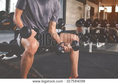 Closeup Of A Thin Man Doing Exercises With Dumbbell. Fitness Muscular Body. Fitness Concept