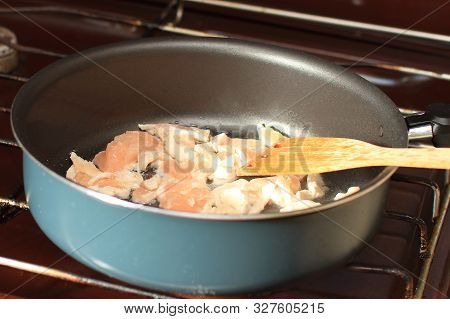 Chicken Meat Is Fried In A Pan On The Stove. The Preparation Of Goulash