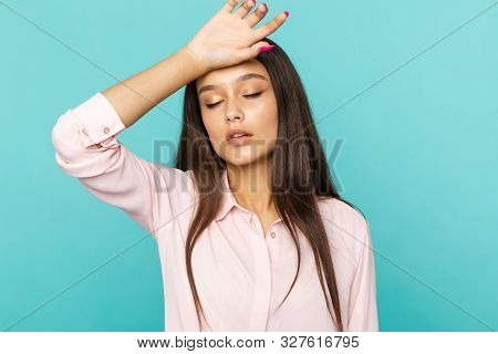 Portrait Of Sleepy And Tired Young Woman Holding Her Handon The Head Isolated.