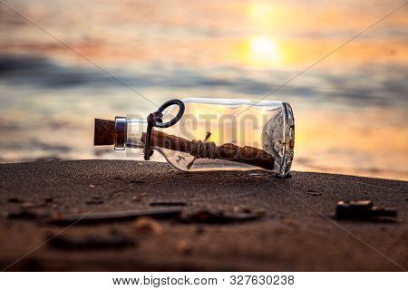 Message in the bottle against the Sun setting down