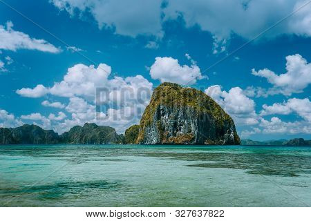 El Nido, Palawan, Philippines. Nature Scenery Of Pinagbuyutan Island On Horizon Under Cloudscape