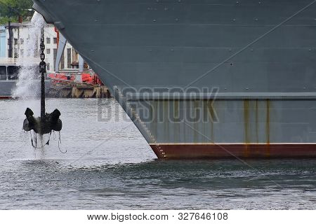 Big Ship Hauling Up The Anchor In Sea Port.