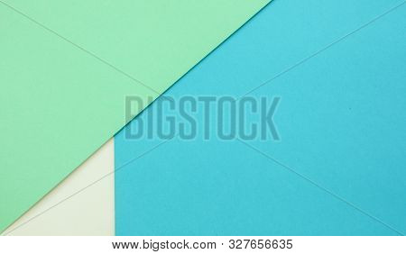 Multicolor Paper Diagonal Background Of Treny Mint, Blue And White Colors. Top View, Copy Space.