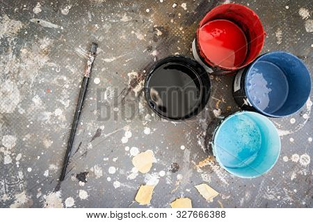 Painting cans on dirty background