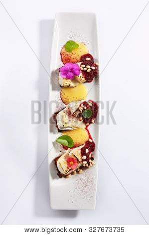 Beetroot carpaccio with stracciatella cheese top view. Vegetarian dish with pear mousse and pine nut. Italian gourmet meal isolated on white background. Served and plated delicious  appetizer 