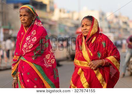 PURI, INDIA, JANUARY 13, 2019 : Two Indian women in traditional saree are walking in the street of the large market near the Shree Jagannath Temple