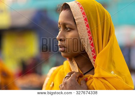 PURI, INDIA, JANUARY 13, 2019 : Profile portrait of Indian women in traditional saree walking in the street of the large market near the Shree Jagannath Temple