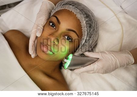 Ultrasound Chromotherapy. Hardware Cosmetology. Beautician Carries Out Procedure For Face Skin Rejuv