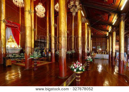 Wooden ancient interior of the Wat Chom Sawan Burmese temple in Phrae, Thailand