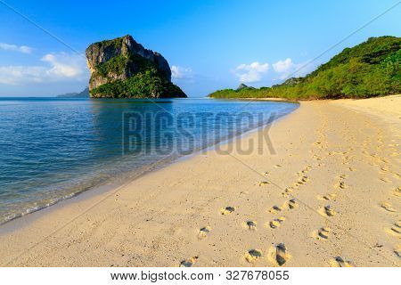 Woman walking on a pure and clean deserted tropical beach, Thailand