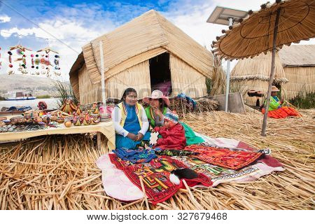 Uros, Peru- Jan 5, 2019: Inhabitants of Uros floating islands sell souvenirs, Titicaca lake, Peru.