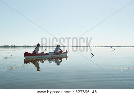 Canoeing in late afternoon sunlight, Lake Tisza, Hungary