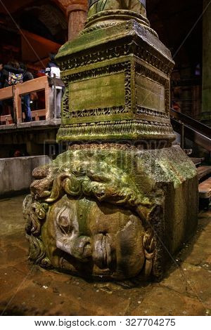 Istanbul, Turkey - March 25, 2019. Upside-down head of Medusa located at northwest edge of the subterranean Basilica Cistern, also known as Yerebatan Sarnici. Ancient Constantinople architecture.