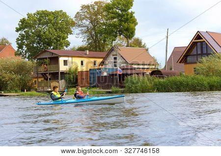 A Girl And A Young Man On A Kayak, Tourists Rafting In A Blue Boat, Matrosovka River, Polessky Distr