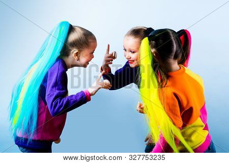 Indoor Shot Of Joyful Attractive Girls Standing And Having A Conversation Between Lessons, Laughing 