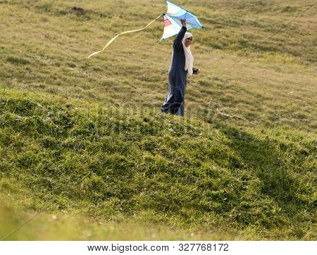 Muslim Arab woman on green meadow