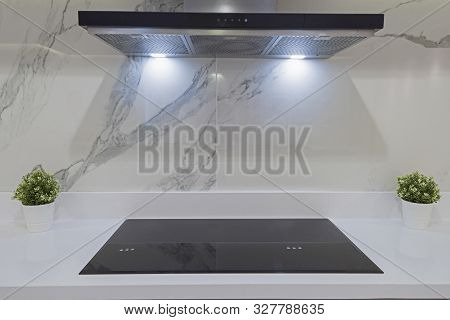 Interior Design Decor Showing Modern Kitchen Cooker Hob Appliance With Extractor Fan In Luxury Apart