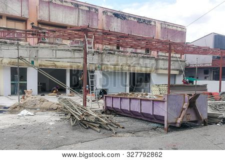 Dumpster Full Load With Construction Site Background