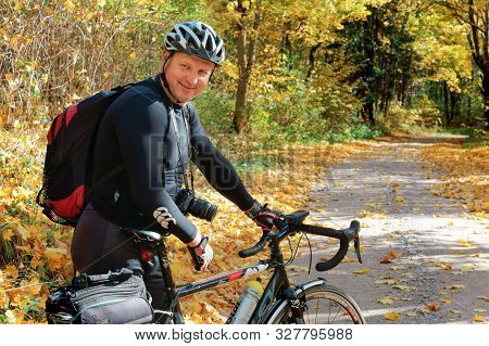 A Man With A Bicycle In Black Clothes, A Cyclist In The Autumn Forest, Rominten Forest, Kaliningrad 