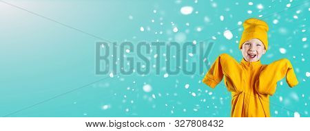 A Cheerful Guy In A Bright Yellow Jacket And Hat Enthusiastically Rejoices On A Mint Background