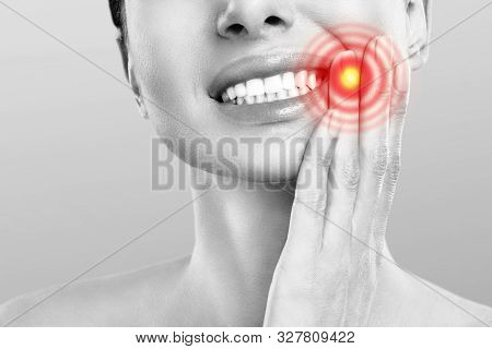 Tooth Pain And Dentistry. Young Woman Suffering From Strong Teeth Pain, Touching Cheek With Hand. Fe