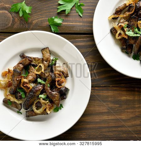 Fried Beef Liver With Onion On Plate Over Wooden Background. Pieces Cooked Liver (offal) From Beef. 