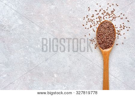 Psyllium Husk Seeds , Fiber Source , In Wooden Spoon On Light Stone Background. Top View With Copy S
