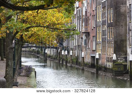 Historic Canal Houses Along The Voorstraathaven With The Bridge Pelserbrug In The Background In Dord