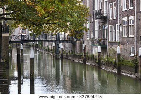 Historic Canal Houses Along The Voorstraathaven With The Bridge Pelserbrug In The Background In Dord