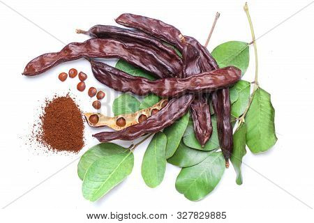 Carob Beans With Carob Powder. Healthy Organic Sweet Carob Pods With Seeds And Leaves On White Backg