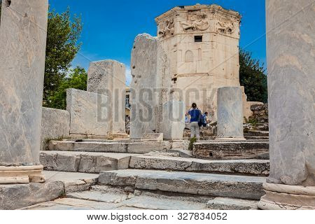 Athens, Greece - April, 2018: Tourists Visiting The Ancient Ruins At The Roman Agora Located To The